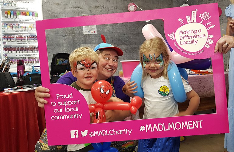 Newly revamped Storrington service station raises £500 for Memory Café face painting with MADL frame