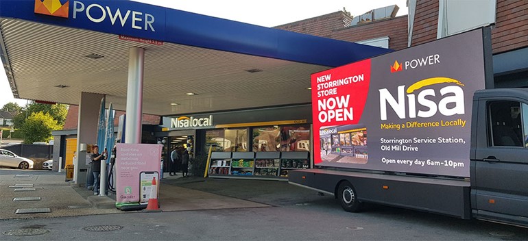 Newly revamped Storrington service station raises £500 for Memory Café Front of service station with Nisa fascia and advert board