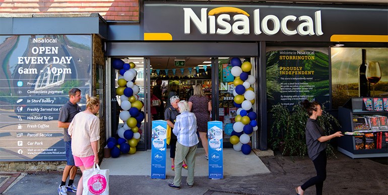 Newly revamped Storrington service station raises £500 for Memory Café Front of store with shoppers and Nisa fascia