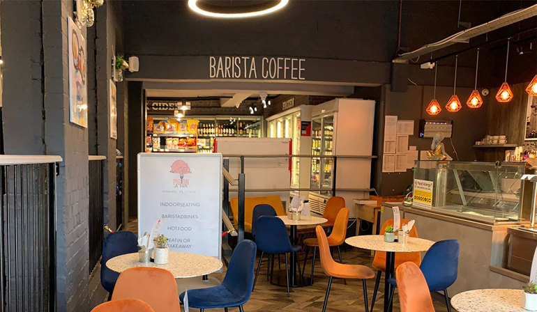 Pint of beer and a basket of shopping cafe seating area in store