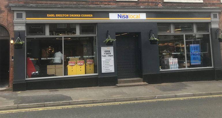 Pint of beer and a basket of shopping Nisa Fascia Front of Store